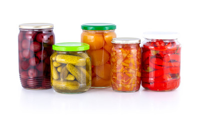 Fototapeta na wymiar Pickled peach, apricot, cherry, cucumber, lecho (lecso), cowhorn chili peppers compote isolated on white with shadow reflection clipping path. Preserved,bottled,stewed fruits & vegetables in glass jar