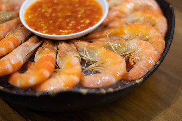 Steamed shrimp on dish with spicy dipping sauce.