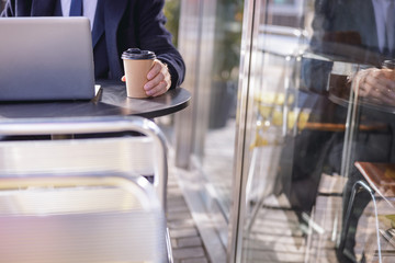 Close up of male hand that holding paper cup