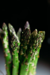 A bunch of green asparagus on a gray table