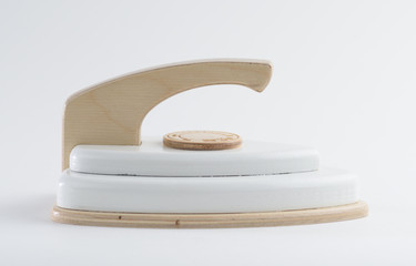 Toy iron made of wood on white background