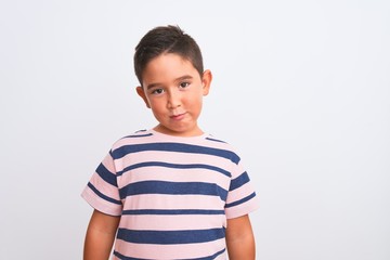 Beautiful kid boy wearing casual striped t-shirt standing over isolated white background depressed and worry for distress, crying angry and afraid. Sad expression.