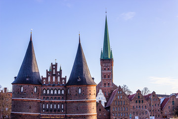 Fototapeta premium Steeples from Holsten Gate and St. Peter’s Cathedral in Lübeck, Germany