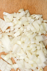 Fototapeta na wymiar Chopped onions on wooden cutting board