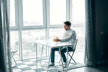 businessman sitting on chair and looking at camera