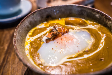 Curried red lentil tomato and coconut soup - delicious vegetarian food on grey background, top view. Flat lay served healthy lunch