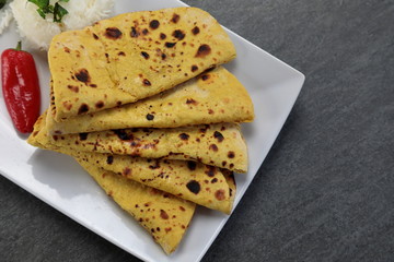 Home made Gluten free Chickpea flour Roti or Besan Roti or Chapati or bread on a plate .
