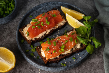 soft cheese and salmon toasts, close-up, top view