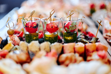 party table with appetizers of vegetables, meat and seafood