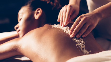 African-american woman having exfoliation treatment in spa