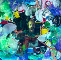 Man drowning in water under plastic recipients pile, garbage. Used bottles and packs filling world ocean killing people. Ecology, environment concept, plastic and glass pollution, nature disaster.
