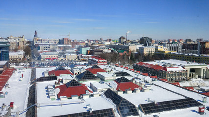 Aerial view of the city. Panoramic view of the rooftops. Roofs of houses in the snow, winter day.