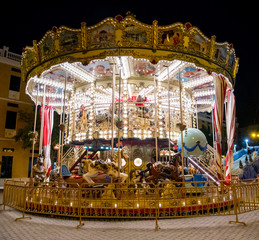 classic carousel illuminated at night at the fair