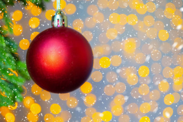 Christmas tree decorated with red ball on pine branches background