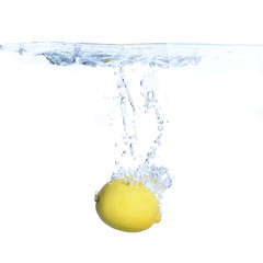 Lemons in the water with bubbles and splashes. Close-up. Isolated on white.Concept and idea with lemons