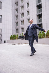 Positive delighted brunette male person going home