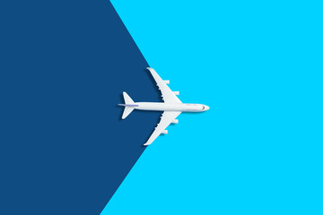 Naklejka na ściany i meble Flat lay design of travel concept with plane on blue background with copy space