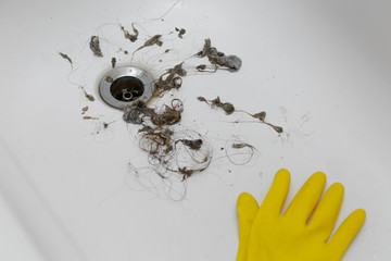 cleaning dirt and hair near drain hole