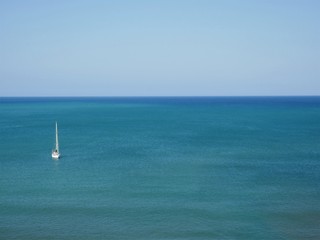 Fototapeta premium Aerial view of the blue sea and sky on a beautiful, calm, sunny day in Cala Millor, Majorca