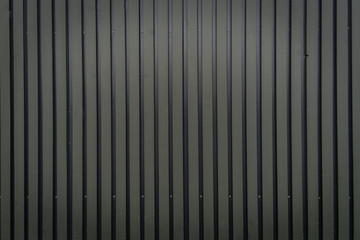Grey vertical ribbed metal fence