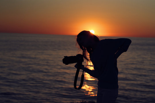 silhouette of girl on the beach at sunset