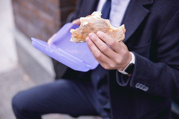 Close up of male hand that holding sandwich