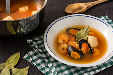 French bouillabaisse soup in white plate	