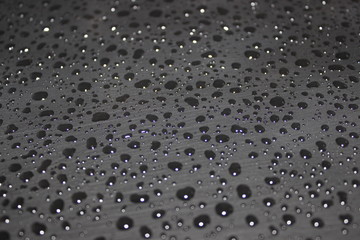 water droplet on a black surface 