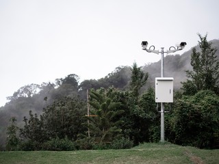 CCTV was installed in the park. closed circuit camera Split with nature background.