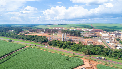 Fototapeta na wymiar Sugar cane industrial mill processing plant in Brazil. Sugarcane plant producing renewable energy. Ethanol.