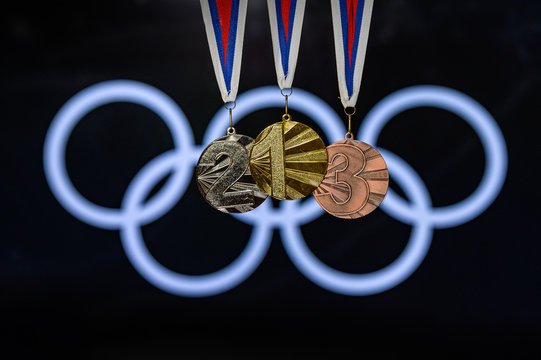 TOKYO, JAPAN, JUNE. 20. 2019: Gold silver and Bronze medal, Sport trophy, olympic logo in background