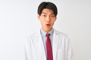 Chinese scientist man wearing tie and coat standing over isolated white background afraid and shocked with surprise expression, fear and excited face.