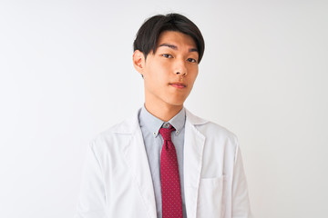 Chinese scientist man wearing tie and coat standing over isolated white background with serious expression on face. Simple and natural looking at the camera.