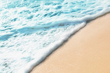 Summer pastel colored background - sandy beach and sea water