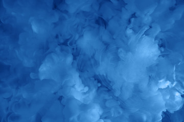 Paints dissolved in water with a beautiful spectacular blur. Trending classic blue colors. Bright amazing abstract background. Smoke effect. Color 2020.