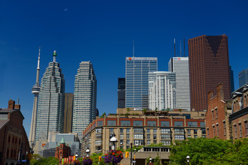 St Lawrence Market and Gooderham Flatiron building with CN tower and financial district bank towers Toronto at half moon