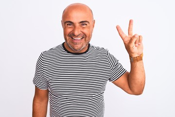 Middle age handsome man wearing striped navy t-shirt over isolated white background showing and pointing up with fingers number two while smiling confident and happy.