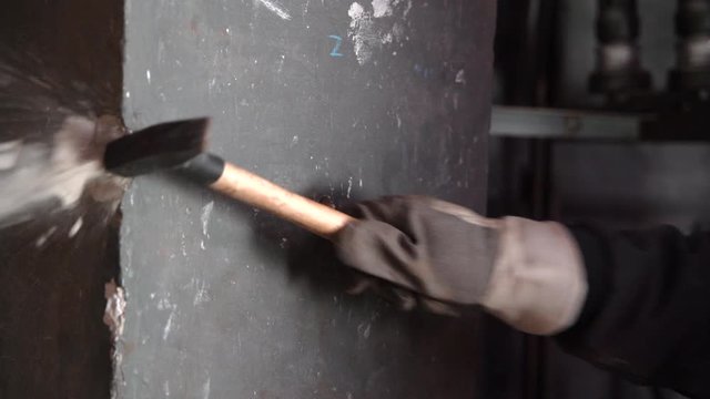 Man wracking wall with the hammer