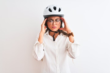 Beautiful businesswoman wearing glasses and bike helmet over isolated white background with hand on head for pain in head because stress. Suffering migraine.