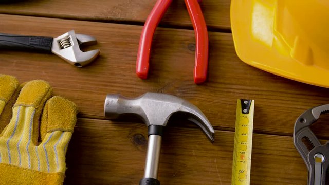 repair, building and carpentry concept - different work tools on wooden boards