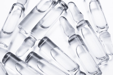 group of glass ampoules with a vaccine on a white background