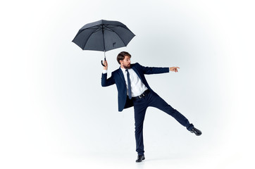 businessman with umbrella - obrazy, fototapety, plakaty