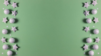 Christmas banner with Xmas decoration, shiny balls and stars on mint background with copy space.