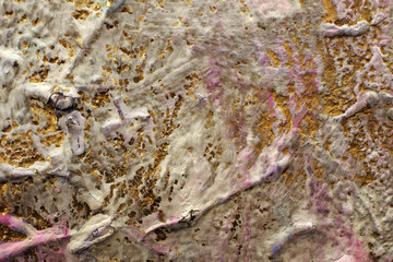 Icing on an ancient gold surface. Multi-layer painting. Сracked paint. Surface of Church utensils