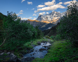 Obraz premium Staubbach with Eiger, Mönch, and Jungfrau in the Evening Light, Switzerland