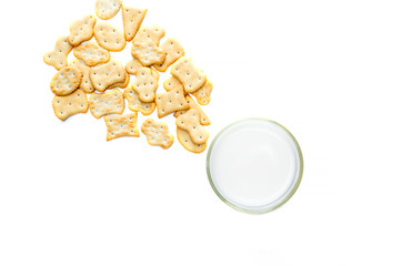 Glass of milk and cookies on white background - top view