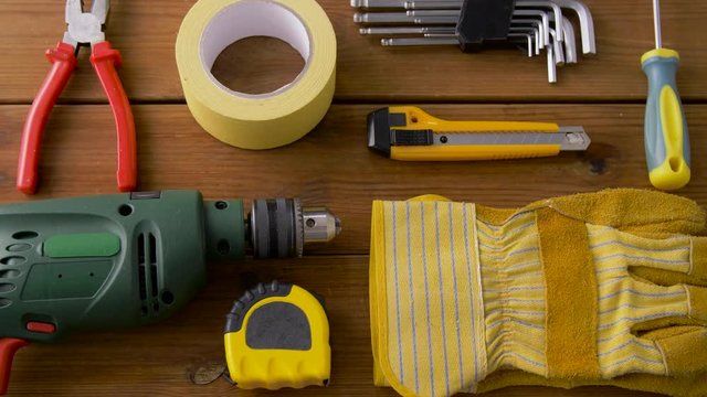 repair, building and carpentry concept - different work tools on wooden boards