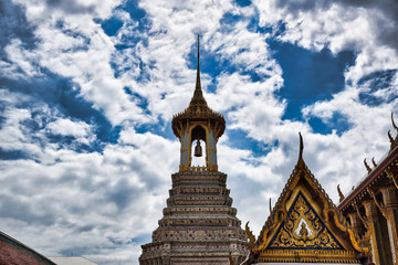Fototapeta na wymiar A Thai traditional bell tower (belfry) with detailed, mosaic artwork and gold colored design at Wat Phra Kaew (Temple of the Emerald Buddha) within the precincts of the Grand Palace of Bangkok