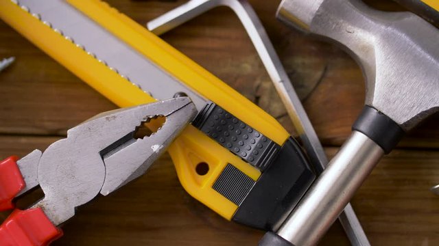repair, building and carpentry concept - different work tools on wooden boards