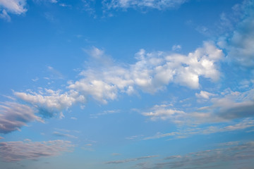 Blue summer sky with bright white cumulus clouds.
